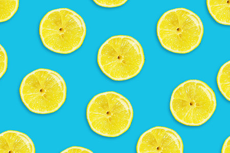 Sliced juicy lemon on a blue background. Fresh fruits. Fruit background. Summer party. Birthday. Bright colorful.の写真素材