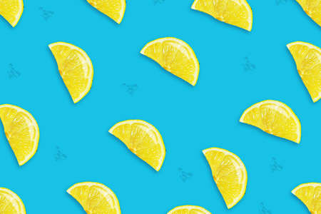 Sliced juicy lemon on a blue background. Fresh fruits. Fruit background. Summer party. Birthday. Bright colorful.の写真素材