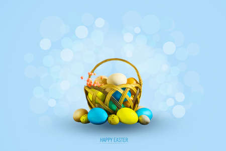 Multi-colored Easter eggs and grass in a basket on a blue background. Copy space. Easter. Background.の写真素材