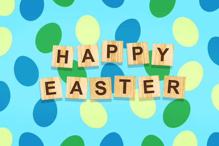 Easter background with colorful eggs on a blue background. The inscription Happy Easter on wooden blocks. Backgrounds Festive backgrounds.の写真素材
