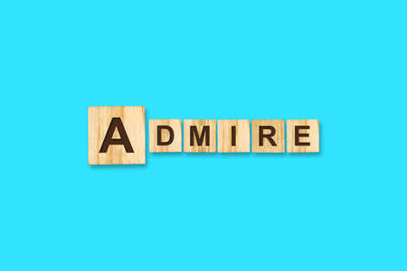 Admire. Words written on a wooden block. Blue background. Isolated. Business concept. Admire conceptの写真素材
