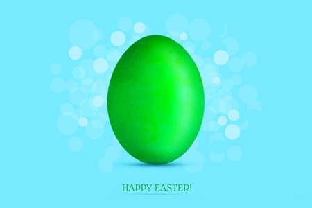 Gren easter egg on a blue background. Easter background. Festive background.の写真素材