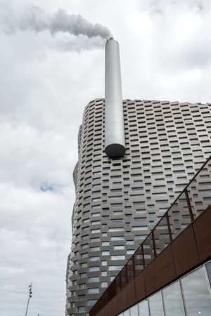 Copenhagen. Denmark. 12. September. 2021. Bottom view, of Amager Bakke factory with a big pipe, and with skiing slope on the rooftop in Copenhagen, Denmark. Sights. Europe.の写真素材