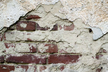 Old red brick with concrete crack. Grunge backgroundの写真素材