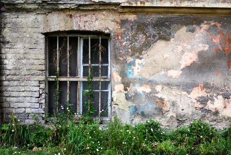 One window on an old concrete wall. Grunge backgroundの写真素材