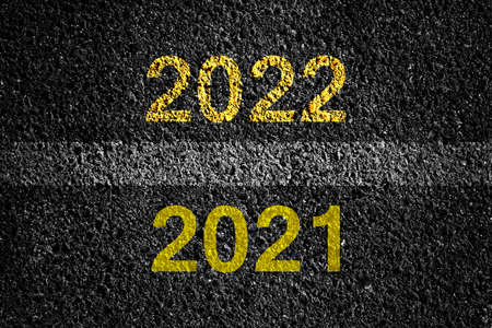 2021, 2022 on asphalt road surface with markings. The concept of the coming New Year, new plans, and...