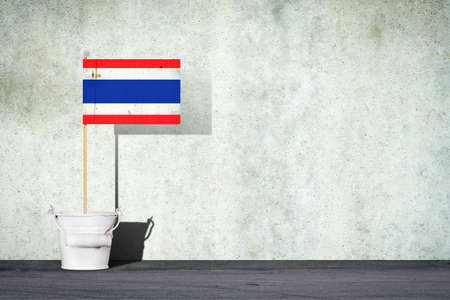 Flag of Thailand, on a stick, in a small bucket, against the background of a concrete wall. Copy space. Signs and Symbols.3D illustration. Flags.の写真素材