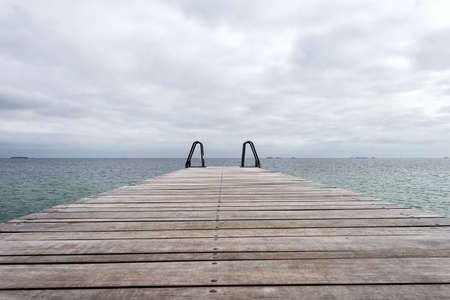 Wooden pier leading to the sea. Baltic Sea, Copenhagen. Denmark. Freedom. Trips Lifestyleの写真素材