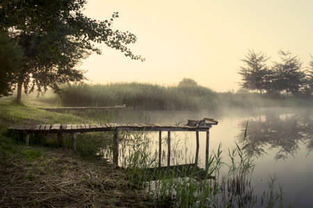 Fishing bridge, morning mist over the waterの写真素材