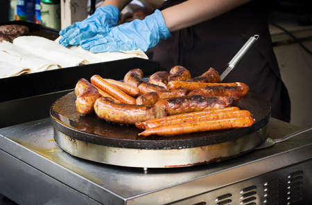 Street food, sausages on grill in roasting processの写真素材