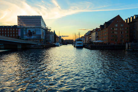 Copenhagen. Denmark. 12. September. 2021. Beautiful colorful buildings, ships, and yachts in Nyhavn on the Sunset. Historical Buildings Sights Europeのeditorial素材