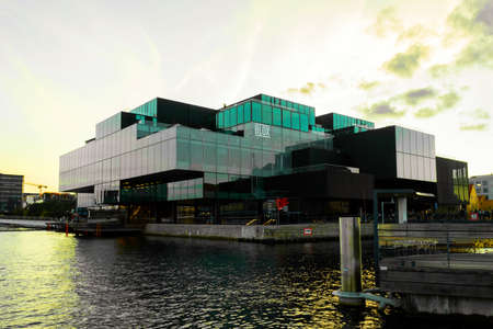 Copenhagen. Denmark. 12. September. 2021. Beautiful modern glass building on the bank of the canal in Copenhagen, on the sunset. Denmark. European architecture. Architecture. Europe.のeditorial素材
