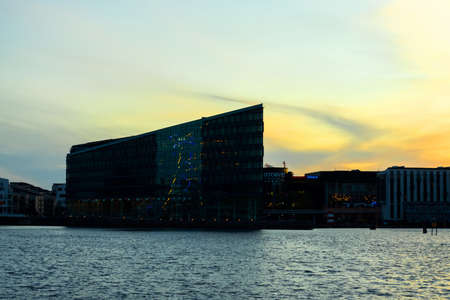 Copenhagen. Denmark. 12. September. 2021. Beautiful modern glass building on the bank of the canal in Copenhagen, on the sunset. Denmark. European architecture. Architecture. Europe.の写真素材