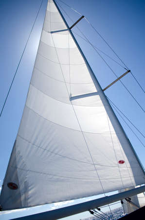 Sail yacht on the background of blue sunny sky