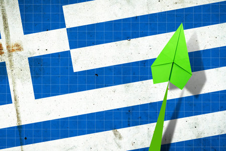Upward arrow on the background of the flag of Greece. Paper plane. Economic recovery. Copy space. Business. Background.の写真素材