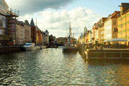 Copenhagen. Denmark. 12. September. 2021. Nyhavn. People are resting on the banks of the canal with...