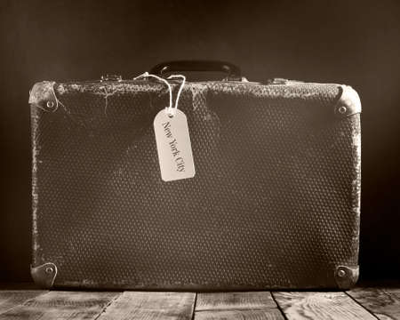 Old vintage suitcase on a wooden floor.Travel concept with a place for the text.Sepia toning