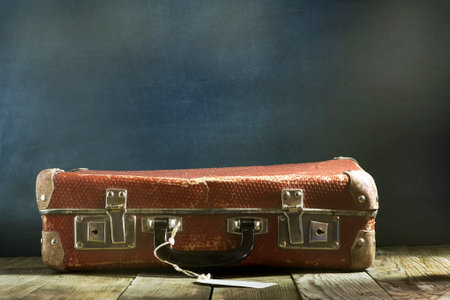 Old vintage suitcase on a wooden floor.Travel concept with a place for the textの写真素材