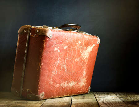 Old vintage suitcase on a wooden floor.Travel concept with a place for the textの写真素材