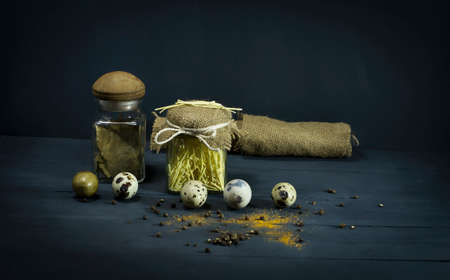 Spices and pasta in jars with quail eggs. On a blue wooden backgroundの写真素材