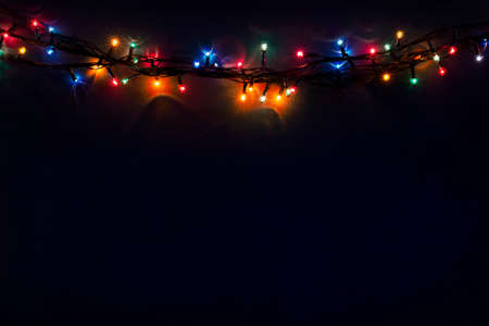 Luminous Christmas gerland on a dark background. Copy space.Christmas, New Year's background.Christmas cardの写真素材