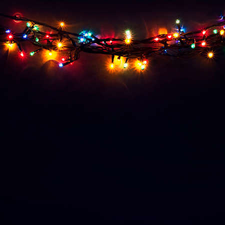Luminous Christmas gerland on a dark background. Copy space.Christmas, New Year's background.Christmas cardの写真素材