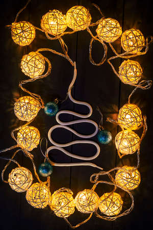 Glowing New Year garlands and ornaments on a dark background. Copy space.Holidays.Christmas, New Year. Cardの写真素材
