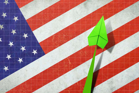 Upward arrow on the background of the flag of America. Paper airplane. Economic recovery. Copy space. Business. Background.の写真素材