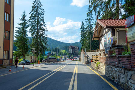 Bukovel. Ukraine. 17.July. 2021. Beautiful streets of the resort, with hotels and holiday cottages, against the backdrop of mountains. Carpathians. Summer rest. Trips.のeditorial素材