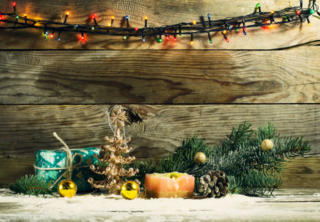 Glowing Christmas tree garland with decorations on a wooden backgroundの写真素材