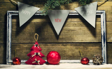 New Year composition with decorations old frame on a wooden backgroundの写真素材