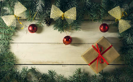 Christmas New year composition with branches of spruce on the old wooden background. Top view with copy spaceの写真素材