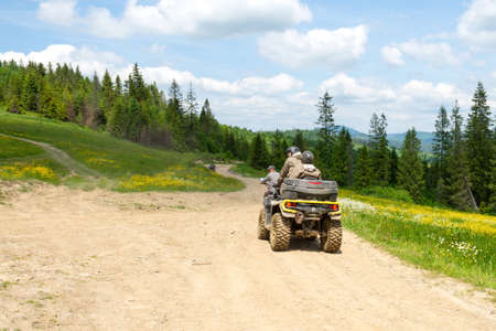 Slavsk. Ukraine. June 20. 2021. Tourists on ATVs on a mountain road. Extreme vacation. Carpathian mountains. Travels.のeditorial素材
