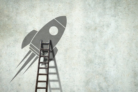 Space rocket on a concrete wall. Ladder to her. Copy space. Concept of a new project. Business.の写真素材