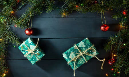 Christmas composition with Christmas tree branches, Christmas toys and gifts. On a blue wooden backgroundの写真素材
