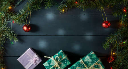 Christmas composition with Christmas tree branches, Christmas toys and gifts. On a blue wooden backgroundの写真素材