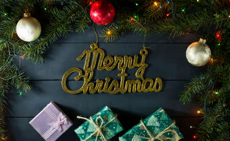Christmas composition with Christmas tree branches, Christmas toys and gifts. On a blue wooden backgroundの写真素材