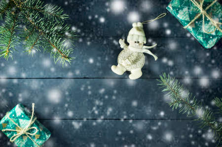 Christmas composition with Christmas tree branches, Christmas toys and gifts. On a blue wooden backgroundの写真素材