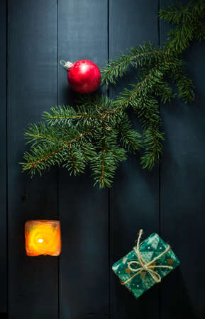 Christmas composition with Christmas tree branches, Christmas toys and gifts. On a blue wooden backgroundの写真素材