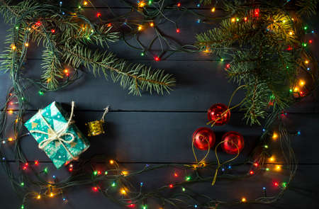 Christmas composition with Christmas tree branches, Christmas toys and gifts. On a blue wooden backgroundの写真素材