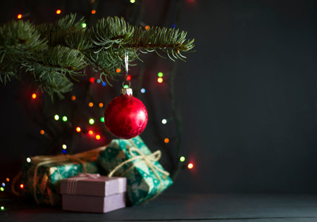 Christmas gifts under a pine tree on a blue wooden backgroundの写真素材