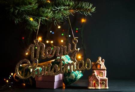 Christmas gifts under a pine tree on a blue wooden backgroundの写真素材