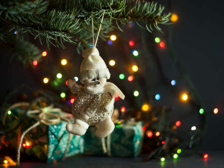 Christmas gifts under a pine tree on a blue wooden backgroundの写真素材
