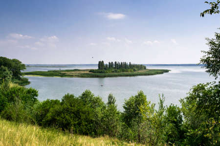 Beautiful view from the mountain to the river with the island on a sunny summer dayの写真素材