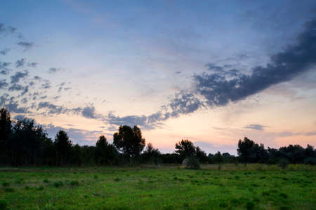 Beautiful sunrise in a field with amazing clouds. Tent. Travels. Tourismの写真素材