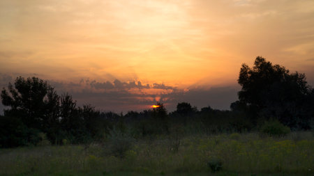 Beautiful sunrise in a field with amazing clouds. Tent. Travels. Tourismの写真素材