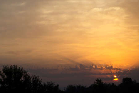 Beautiful sky with amazing clouds at sunrise. Summer morningの写真素材