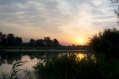 Beautiful colorful sunrise over the river. Recreation. Travels. Tourism Fishingの写真素材