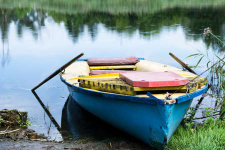 An old boat on the river bank. Summer sunny day. Rest, travel.の写真素材