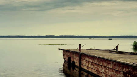 Old pier for boats on the river. Travel. Tourism. Recreationの写真素材